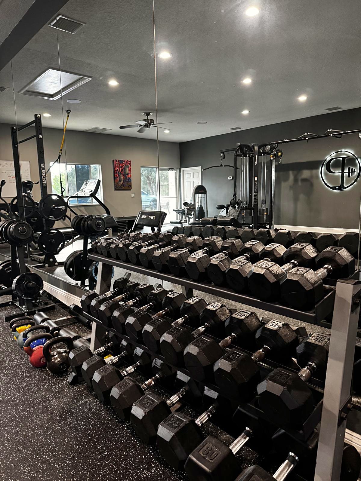 Rows of dumbbell racks in the Platinum training studio