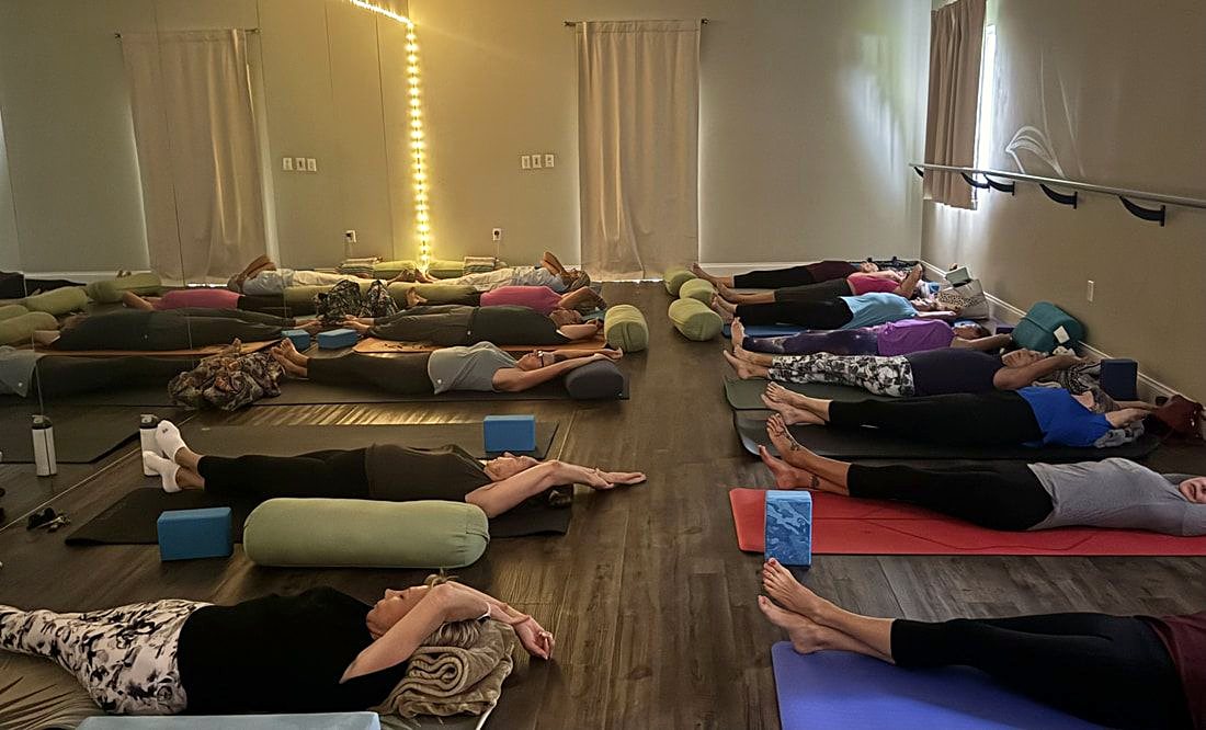 Restorative yoga class with bolsters and blocks at Platinum
